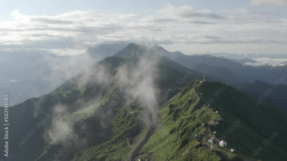 Aerial raising up to top shot. Mountain ridge panorama flight through the clouds sunrise organic morning environment. Shooting from drone picturesque cliff nature terrain ecology resort forecast tour Aerial raising up to top shot. Mountain ridge panorama flight through the clouds sunrise organic morning environment. Shooting from drone picturesque cliff nature terrain ecology resort forecast tour