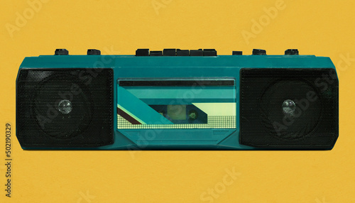 Retro blue portable radio cassette recorder from 80s isolated on yellow background, pop art design, close up