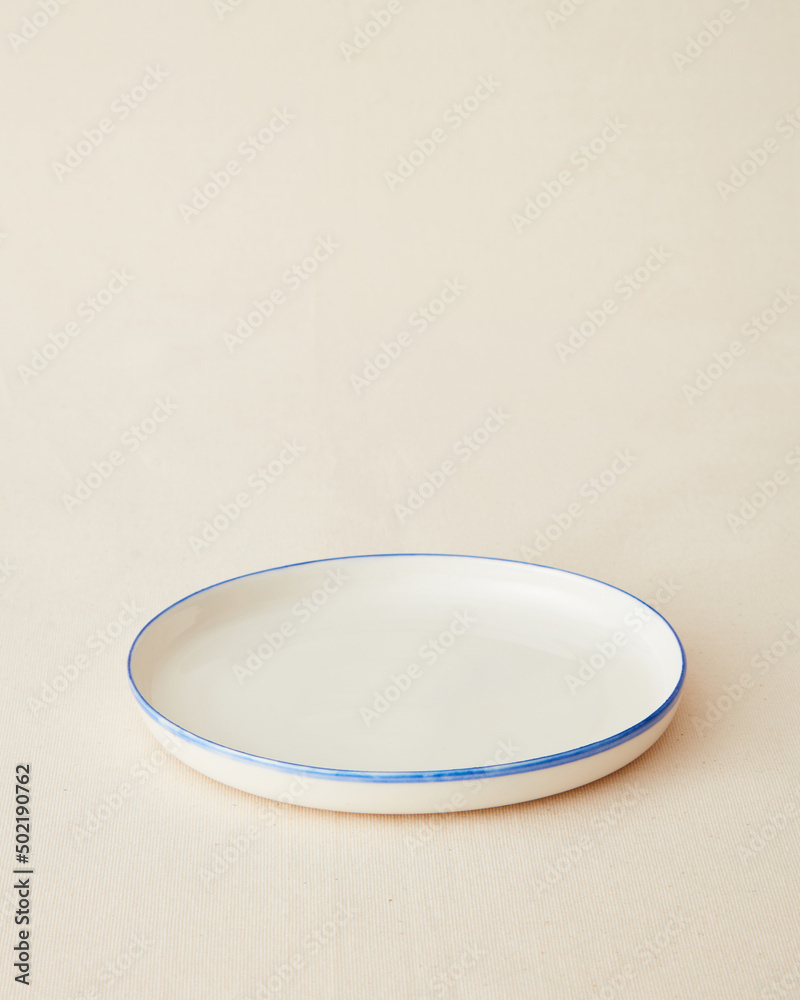 Handmade ceramic plate on beige background. Handmade ceramic plate on beige background.
