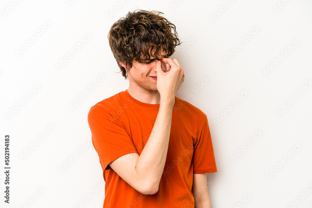 Young caucasian man isolated on white background having a head ache, touching front of the face. Young caucasian man isolated on white background having a head ache, touching front of the face.