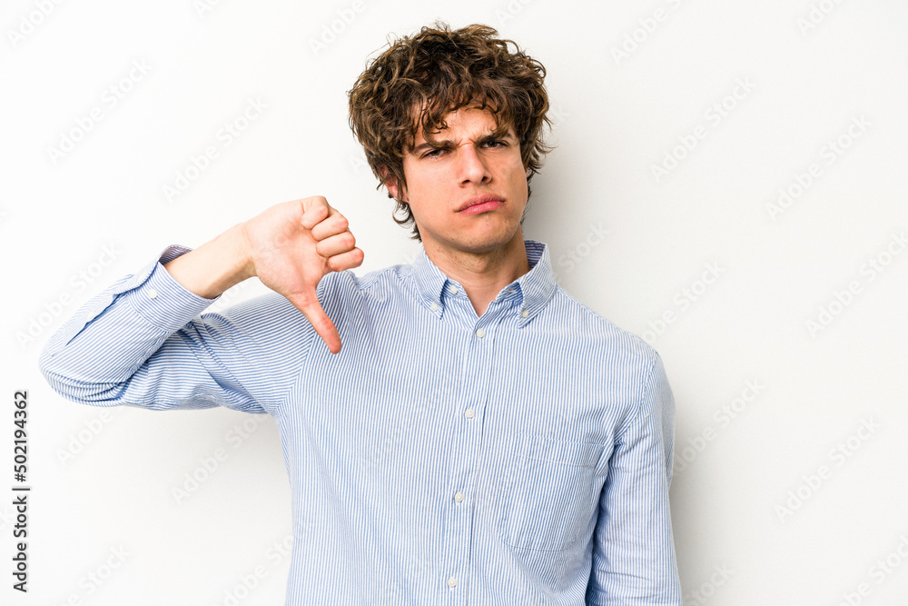 Young caucasian man isolated on white background showing thumb down and expressing dislike. Young caucasian man isolated on white background showing thumb down and expressing dislike.