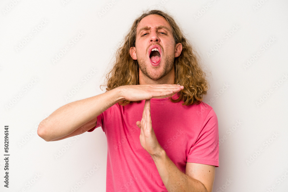 Young caucasian man isolated on white background showing a timeout gesture. Young caucasian man isolated on white background showing a timeout gesture.