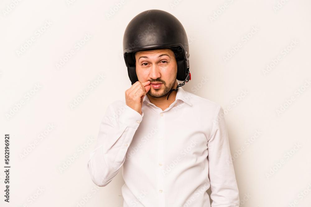 Hispanic business man going to work with motorcycle isolated on white background with fingers on lips keeping a secret. Hispanic business man going to work with motorcycle isolated on white background with fingers on lips keeping a secret.