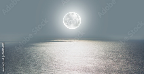Moon rise in the clouds over the sea at night 