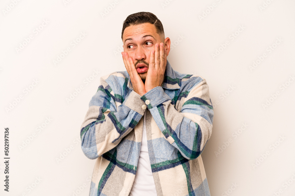 Fototapeta premium Young hispanic man isolated on white background scared and afraid.