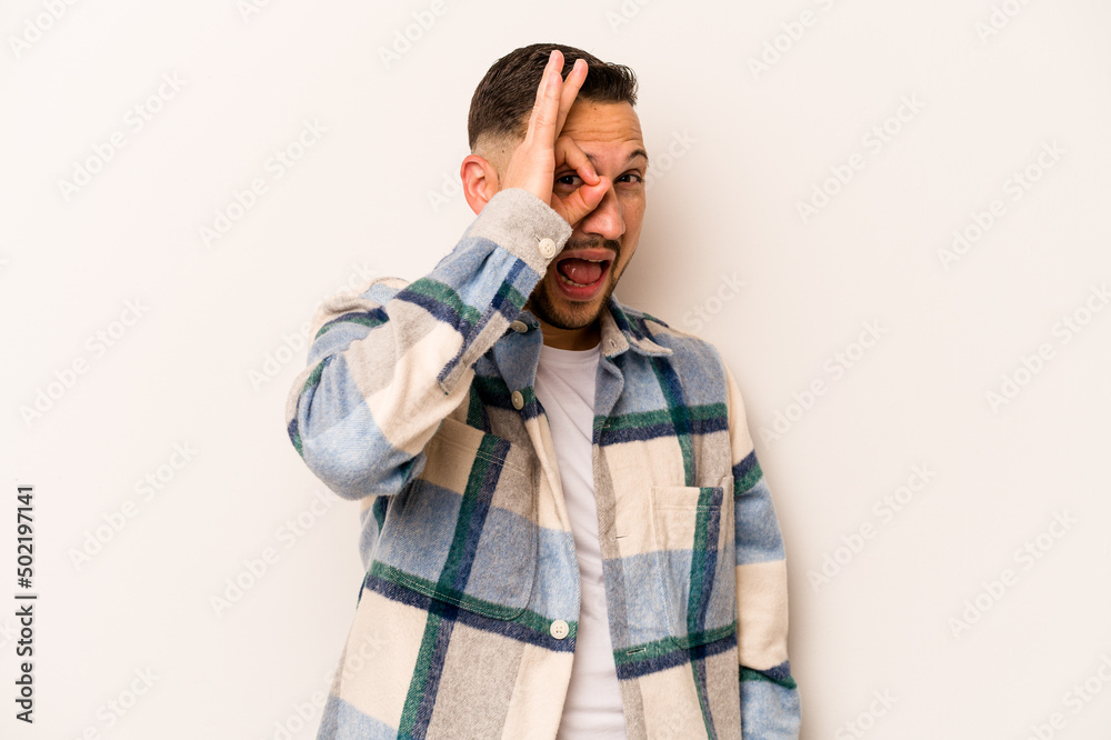 Young hispanic man isolated on white background excited keeping ok gesture on eye. Young hispanic man isolated on white background excited keeping ok gesture on eye.