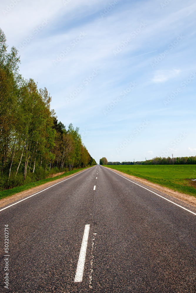 an empty paved road in the countryside