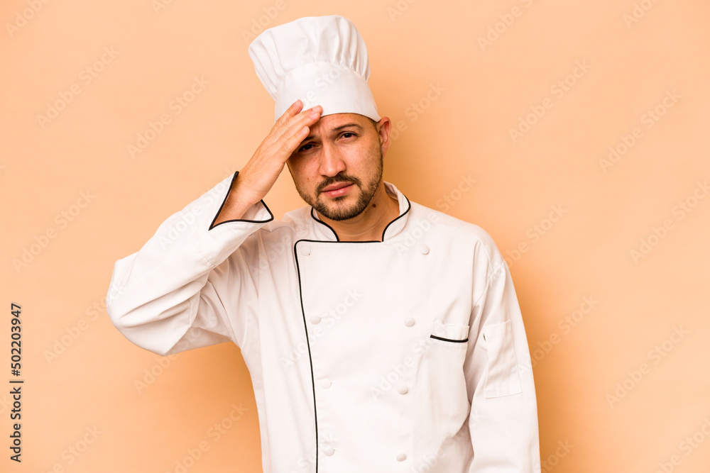 Hispanic chef man isolated on beige background being shocked, she has remembered important meeting. Hispanic chef man isolated on beige background being shocked, she has remembered important meeting.