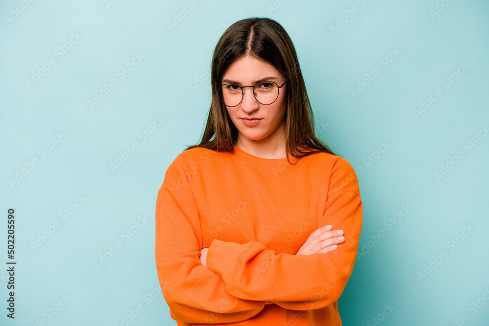 Young caucasian woman isolated on blue background unhappy looking in camera with sarcastic expression.
