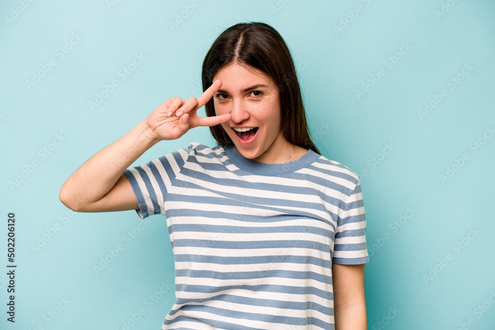 Young caucasian woman isolated on blue background dancing and having fun. Young caucasian woman isolated on blue background dancing and having fun.