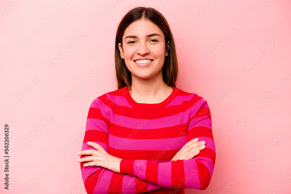 Fototapeta premium Young caucasian woman isolated on pink background who feels confident, crossing arms with determination.