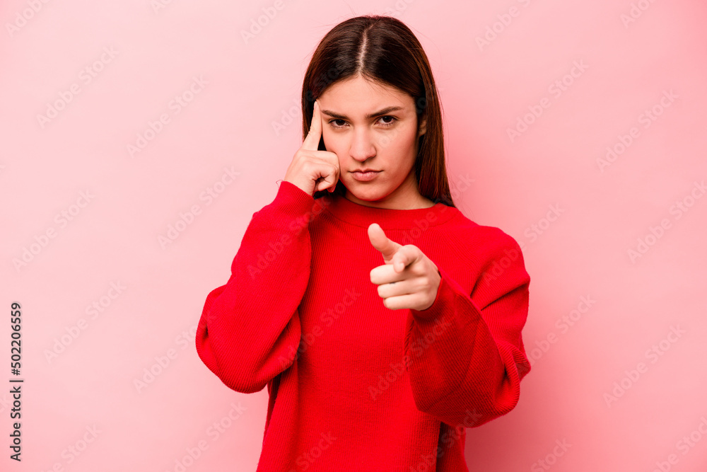 Young caucasian woman isolated on pink background pointing temple with finger, thinking, focused on a task. Young caucasian woman isolated on pink background pointing temple with finger, thinking, focused on a task.