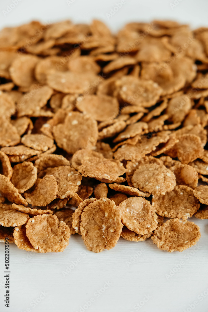 Crispy healthy dry cereal flakes on white background Crispy healthy dry cereal flakes on white background