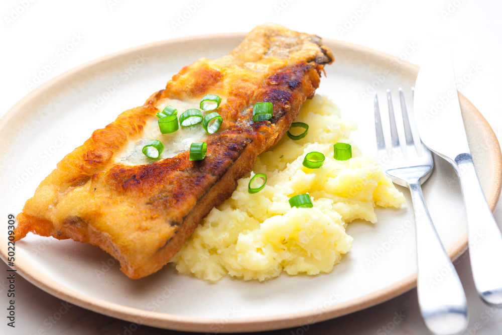 fried fish with mashed potatoes and spring onion