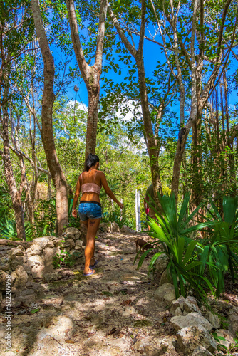 Beautiful pretty woman walks in tropical jungle Mexico.