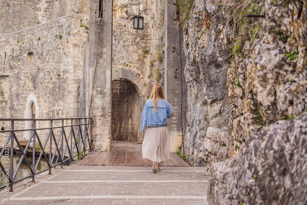Woman tourist enjoying Colorful street in Old town of Kotor on a sunny day, Montenegro. Travel to Montenegro concept Woman tourist enjoying Colorful street in Old town of Kotor on a sunny day, Montenegro. Travel to Montenegro concept