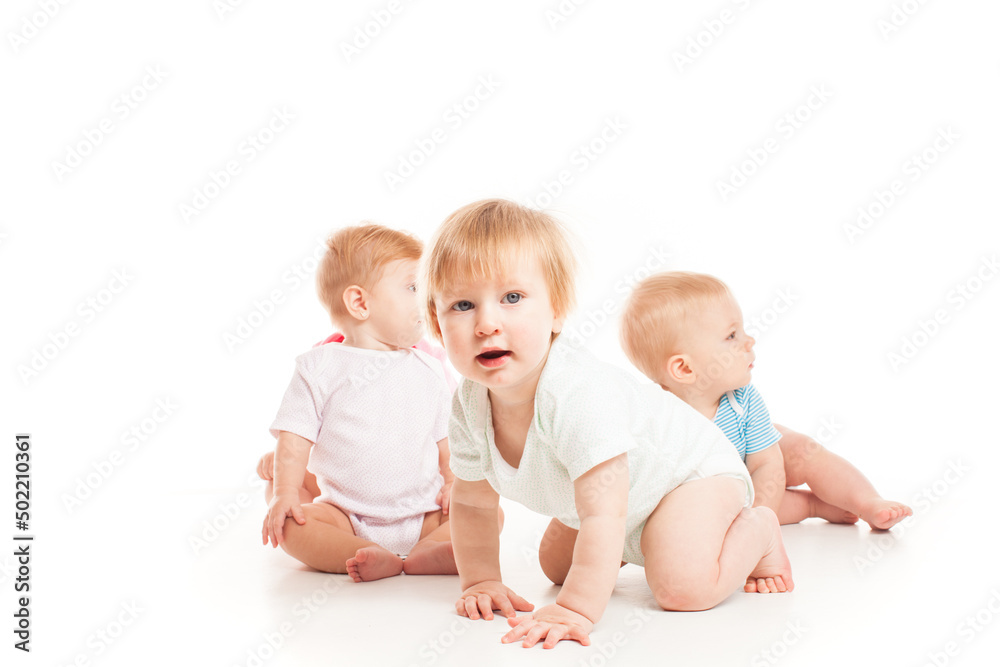 Three babies sitting isolated on the white Three babies sitting isolated on the white