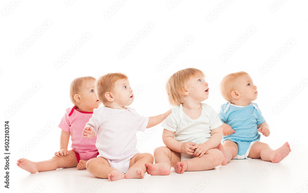 Five babies isolated looking away isolated on white Five babies isolated looking away isolated on white