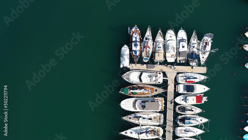 Aerial view of large and small yachts and sailboats moored at the quay. Action. Top view of Boats in Procida, Italy