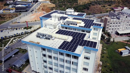 Obraz na płótnie Top view of roof of white building with solar panels