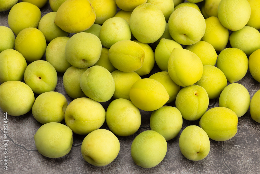 Pile of Chinese plum or Japanese apricot on texture background