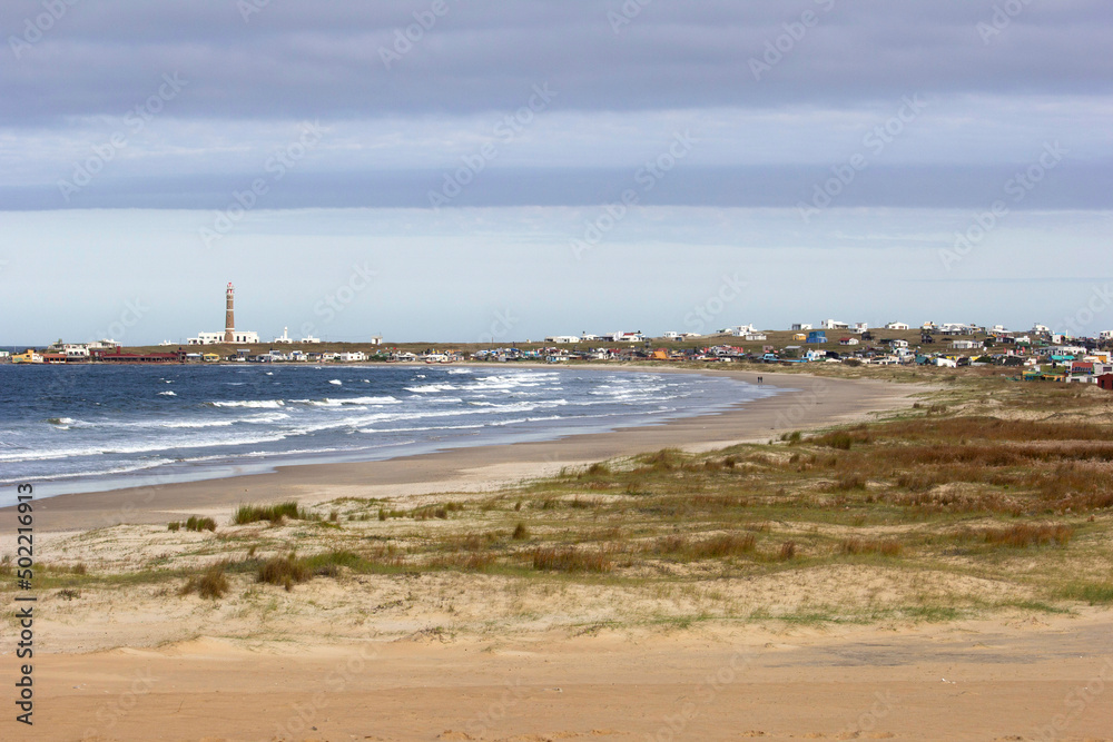View of Cabo Polonio, a small village in Uruguay, Alternative Community. Important tourist spot, located on the coast, it is possible to see sea, beach, sky, lighthouse, ocean, stones, rocks.