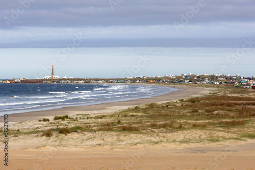 View of Cabo Polonio  a small village in Uruguay  Alternative Community. Important tourist spot  located on the coast  it is possible to see sea  beach  sky  lighthouse  ocean  stones  rocks.
