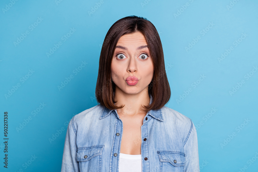 Portrait of adorable young person kiss lips look camera isolated on pastel blue color background Portrait of adorable young person kiss lips look camera isolated on pastel blue color background