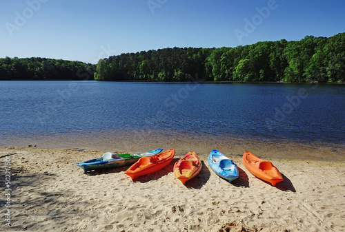 Colorful kayaks on the shore of Lake Johnson, a popular city park in Raleigh NC