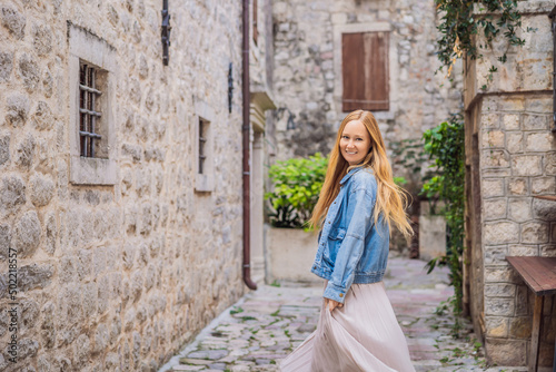 Woman tourist enjoying Colorful street in Old town of Kotor on a sunny day, Montenegro. Travel to Montenegro concept