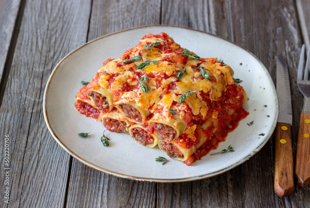 Cannelloni with meat, cheese, tomatoes and thyme. Italian cuisine. Cannelloni with meat, cheese, tomatoes and thyme. Italian cuisine.