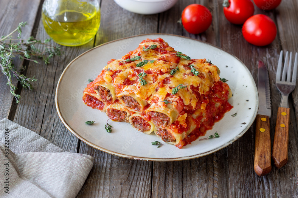 Cannelloni with meat, cheese, tomatoes and thyme. Italian cuisine. Cannelloni with meat, cheese, tomatoes and thyme. Italian cuisine.