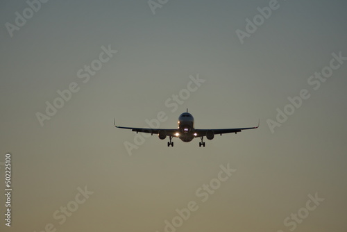 Commercial jet flying, in silhouette, in the evening, in Fort Lauderdale, Florida, USA