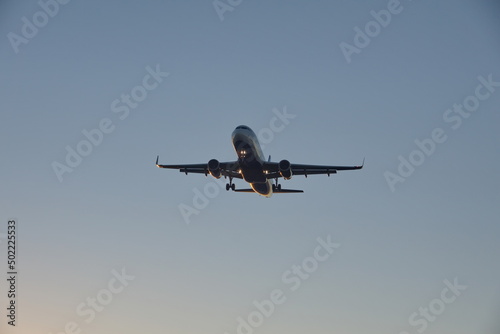 Commercial jet flying, in silhouette, in the evening, in Fort Lauderdale, Florida, USA