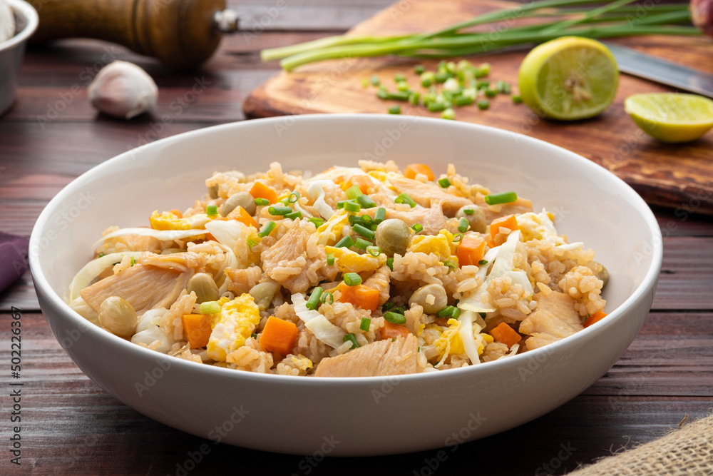 Fried rice with chicken and vegetables in white plate Fried rice with chicken and vegetables in white plate