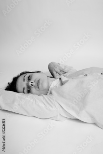 brunette woman lies on the floor, black and white photo