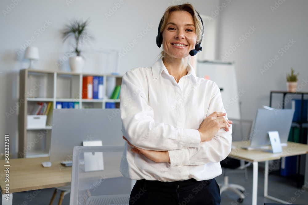 Portrait of smiling female helpline operator in headset Portrait of smiling female helpline operator in headset