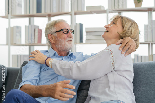 Happy senior couple family  caucasians mature  adult lover and retired man  woman embracing  hugging make romantic  empathy on sofa  couch at home together. Smile  husband and his wife lifestyle.