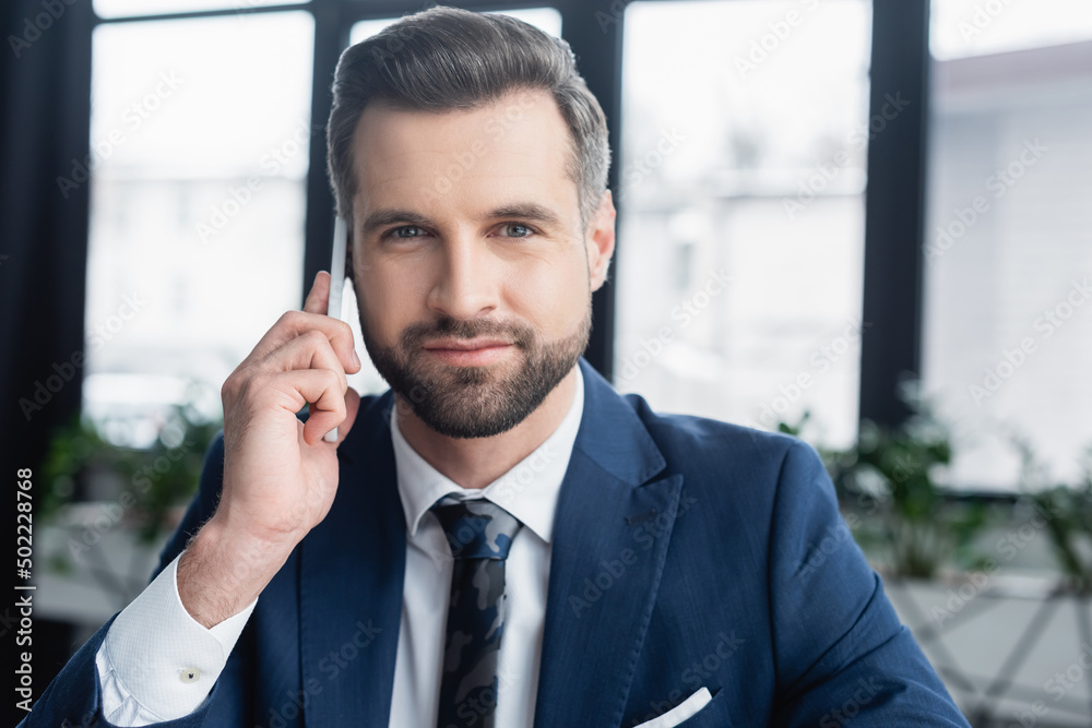 brunette economist in blazer and tie calling on mobile phone and looking at camera. brunette economist in blazer and tie calling on mobile phone and looking at camera.