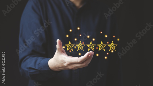 Customer service business satisfaction survey concept, men's hand showing 5 stars symbol, showing satisfaction indicates excellent service quality, ISO compliant.