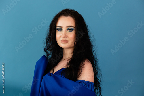 Portrait of a girl on a blue background with patriotic makeup