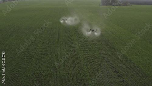 Agro drone works on the field. Field treatment with chemicals. Spraying pesticides against pests. Innovations in the agricultural sector. New technologies. Aerial. 