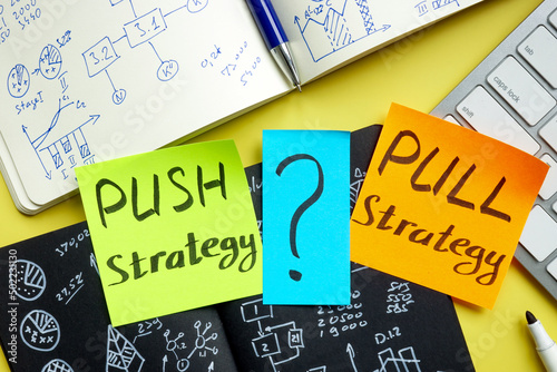 Push or pull strategy in marketing. Notepads and keyboard. photo