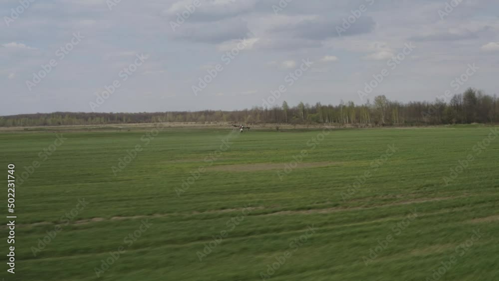 Agro drone works on the field. Field treatment with chemicals. Spraying pesticides against pests. Innovations in the agricultural sector. New technologies. Aerial. Agro drone works on the field. Field treatment with chemicals. Spraying pesticides against pests. Innovations in the agricultural sector. New technologies. Aerial.