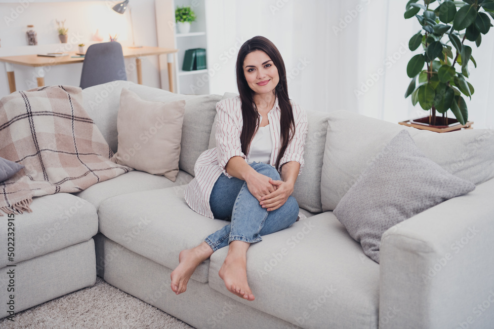 Portrait of attractive cheerful healthy long-haired woman sitting on cosy comfy divan day off at home indoors Portrait of attractive cheerful healthy long-haired woman sitting on cosy comfy divan day off at home indoors
