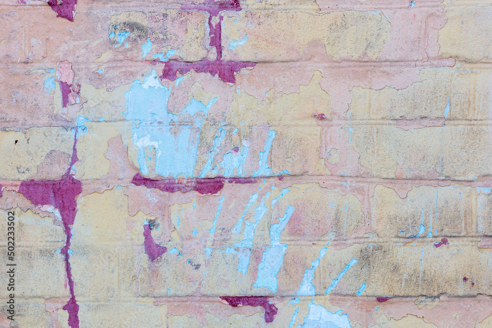 Background of old vintage dirty brick wall with peeling plaster and paint