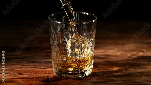 Detail of pouring whisky into glass.