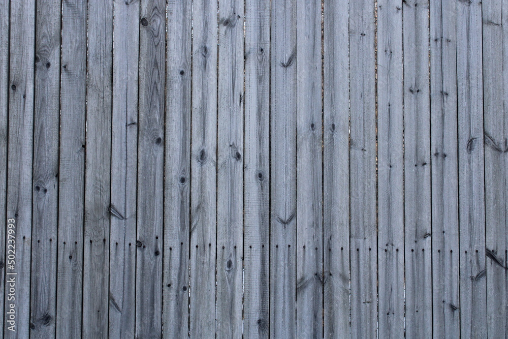 The background is made of light gray wooden boards. Private house, farm. The background is made of light gray wooden boards. Private house, farm.