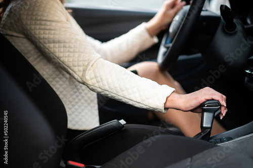 Close up of hand of female driver shifting gear stick before driving car © Minerva Studio