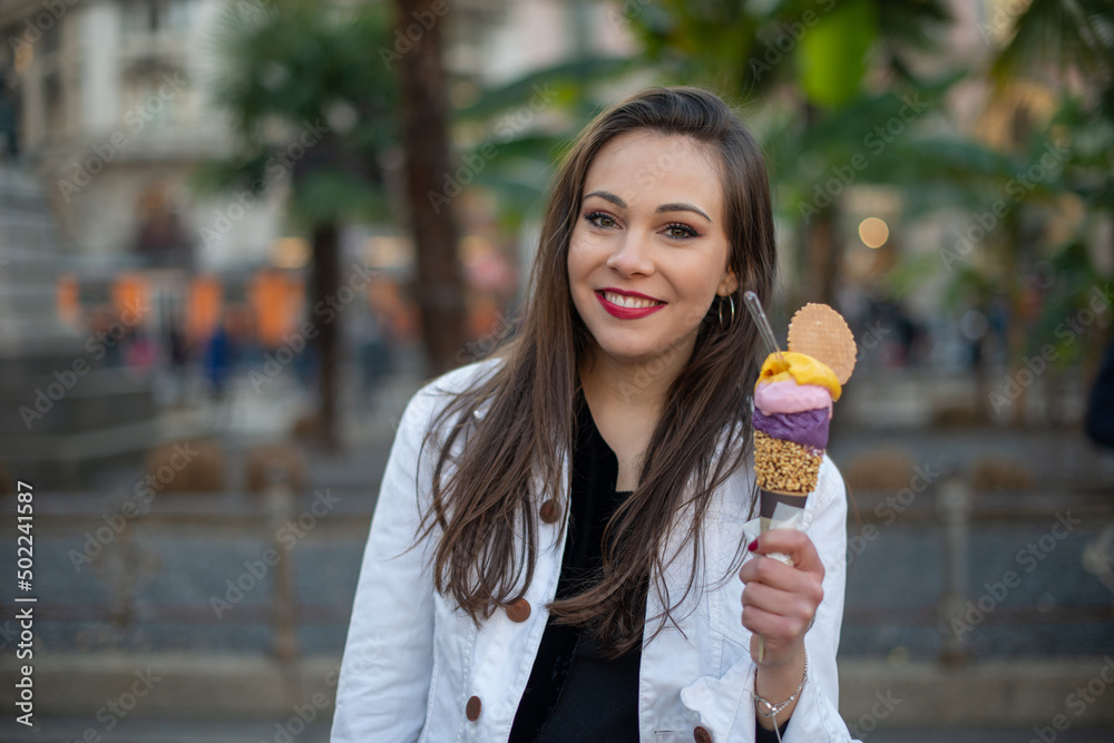 Fototapeta premium Woman eating an ice cream cone outdoor
